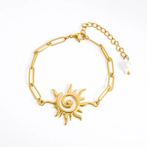 Golden sun pendant bracelet with paperclip chain and white pearl drop on white background