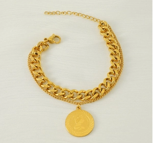 Detail of gold double-layer titanium bracelet with coin pendant and polished chain