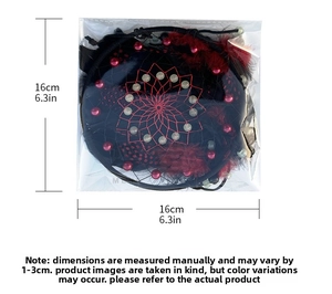 Close-up of a black and red dream catcher showing feathers and 16cm size measurement