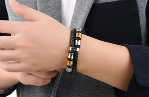 Detail of men's double-layer braided leather bracelet with gold and silver magnetic clasp