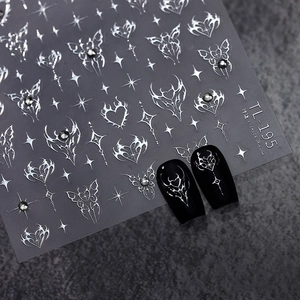 Gothic style silver butterfly and star nail stickers with metallic finish on black nails