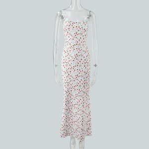 Detail of white floral sundress showing delicate red flower patterns and lightweight fabric