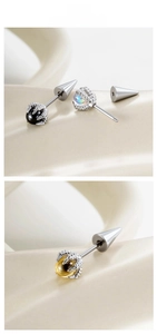 Macro view of dragon claw earrings with colorful gemstones and steel punk style design