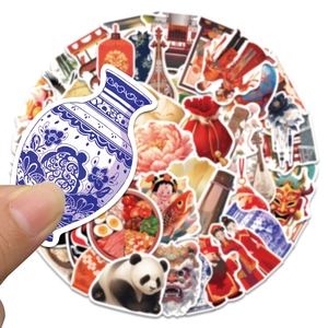 Close-up of hand picking Chinese vintage stickers with panda and blue porcelain motifs
