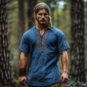 Men's blue linen short sleeve shirt with viking embroidery in a forest setting