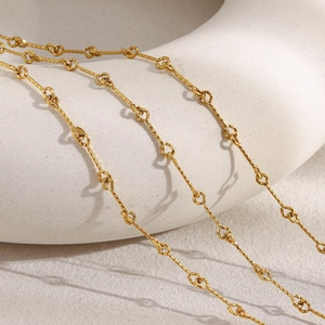 Macro shot of 18K gold plated minimalist chain necklace with textured irregular links