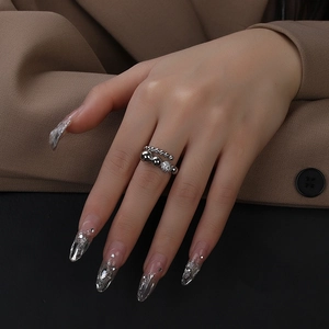 Close-up of silver beaded irregular ring with sparkling zircon detail on model's hand