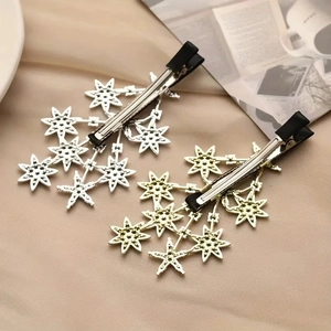 Sparkling star-shaped hair clips in gold and silver finish with rhinestones for women