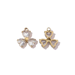 Detailed macro view of gold heart-shaped zircon pendants showing front and back structure
