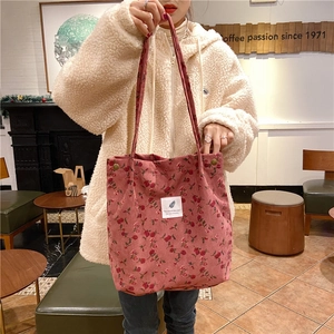 Detailed close-up of pink floral corduroy tote bag featuring soft rose patterns