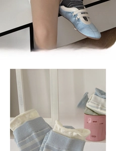Detail of light blue striped cotton socks with ribbed cuffs shown in a lifestyle view