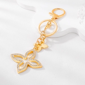 Sparkling gold four-leaf flower keychain with rhinestones and lobster clasp accessory