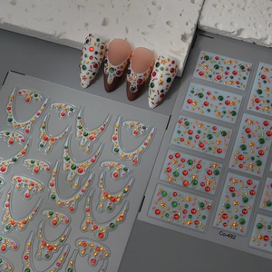 Christmas nail art stickers with red, green, and gold rhinestone designs for holiday parties