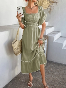 Detail of green square neck dress with ruffled sleeves in a bohemian vacation style