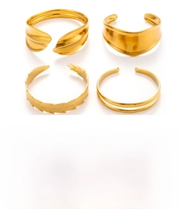 Detailed view of four adjustable gold stainless steel bangles with unique textured designs