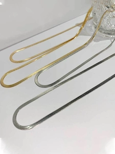 Flat snake chain necklaces in gold and silver finish with sleek metallic textures