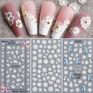Detail of 5D white floral lace nail art stickers with embossed patterns and letters