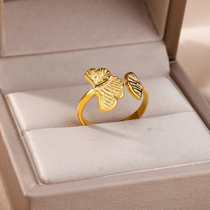 Macro detail of gold-plated ginkgo leaf ring with intricate texture in a jewelry box