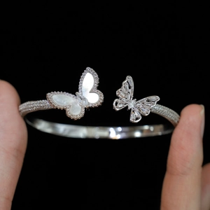Macro shot of silver butterfly cuff bracelet with white mother of pearl and zircon stones