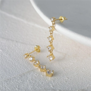 Detail of S925 sterling silver drop earrings with golden chain and white zircon beads