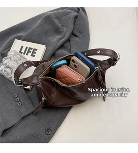 Detail view of large dark brown leather half-moon bag showing spacious interior capacity