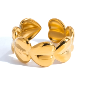 Detailed view of polished gold heart-shaped elements on a stainless steel open ring
