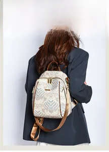 Detail view of ethnic backpack featuring blue and orange traditional wave patterns