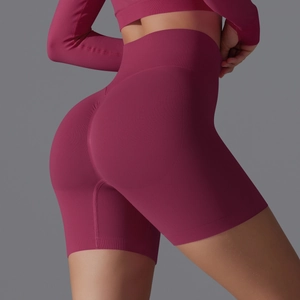 Detail of high-waisted seamless scrunch butt yoga shorts in berry red with ribbed waistband