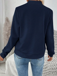 Rear view of a navy blue long-sleeve jacket featuring geometric quilted texture details