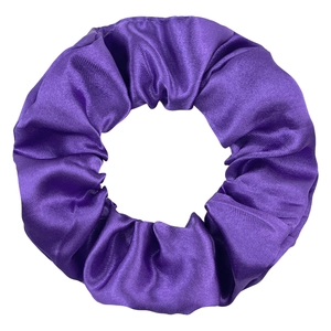 Macro detail of glossy purple satin fabric scrunchie with soft silk-like texture