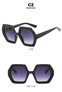 Detail view of large hexagonal sunglasses in glossy black frame with purple gradient lenses