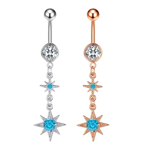 Detail of silver and rose gold star belly rings with blue and clear zircon crystals