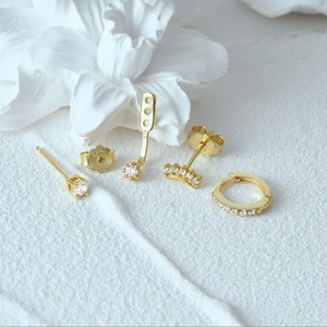 Macro view of gold S925 sterling silver evil eye earring set with clear zircon stones