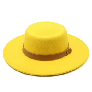 Detail of yellow wool felt boater hat featuring brown leather band and gold buckle