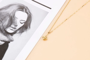 Detailed view of elegant gold heart pendant necklace with double-style chain
