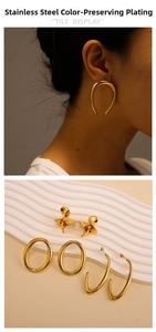 Detail of 18K gold plated stainless steel chunky C-shaped hoop earrings on a model