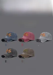 Collection of washed cotton baseball caps with M HAN embroidery in five vintage colors