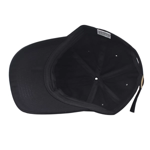 Detail view of cotton baseball cap interior featuring a 100% cotton label and strap
