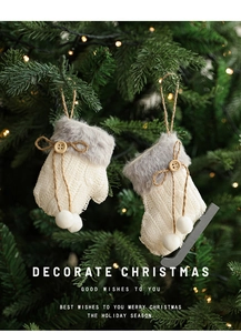 Close-up of knit Christmas mitten ornaments with faux fur trim on a decorated tree
