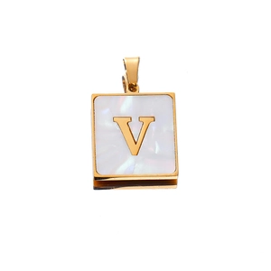 Macro view of a 22mm golden square pendant featuring white shell inlay and a gold letter V