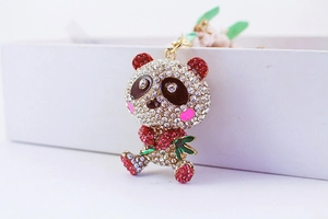 Macro view of panda keychain with sparkling crystals and green bamboo leaf detail