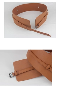 Detail of brown wide leather waist belt featuring a classic metallic buckle and smooth finish
