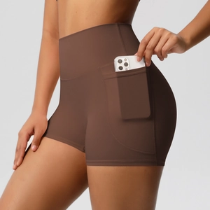 Close-up of high-waist yoga shorts in brown with a functional side phone pocket