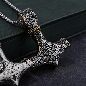 Detail of Mjölnir pendant with intricate Celtic knotwork and antique metal finish