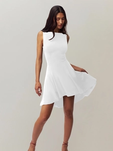 Detail of white sleeveless slimming dress showing waist cut and flowy A-line hem fabric