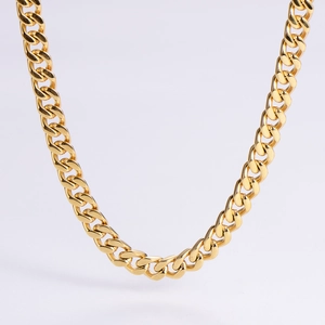 Macro detail of high-polish gold Cuban link chain showing flat links and smooth surface