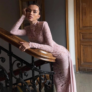 Detail of pink lace maxi dress with high neck and long sleeves in vintage setting