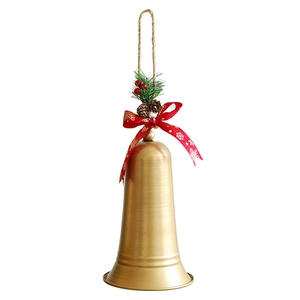 Golden Christmas metal bell with red ribbon bow and pine cone ornament decoration