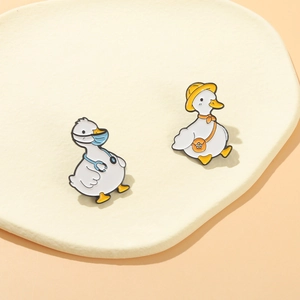 Cartoon duck enamel pin set featuring doctor and traveler characters on a cream tray