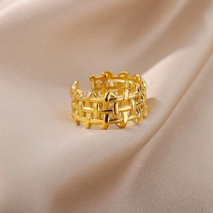 Detail of 18k gold plated punk woven ring showing polished hollow pattern on silk background